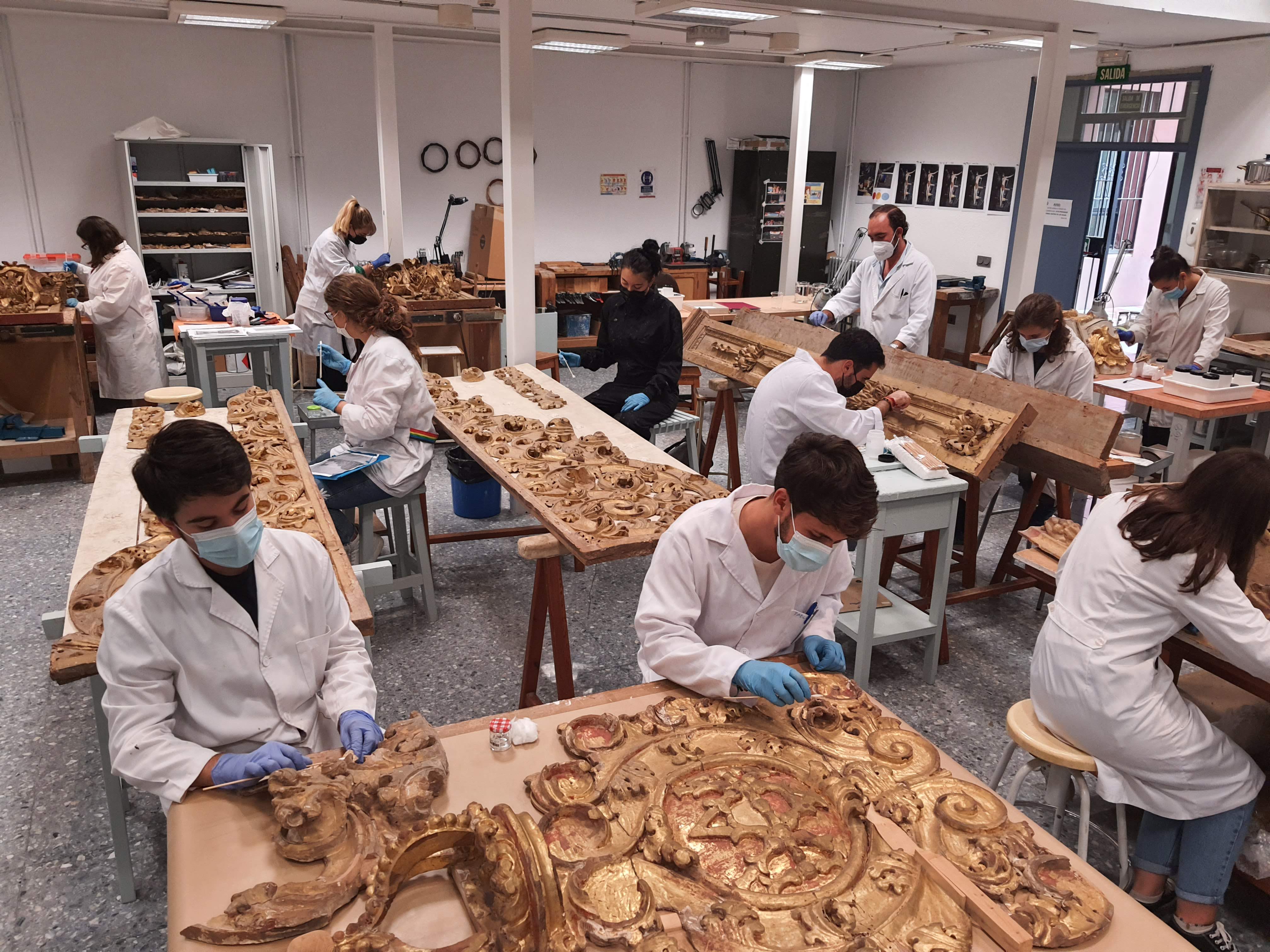alumnos restaurando un retablo
